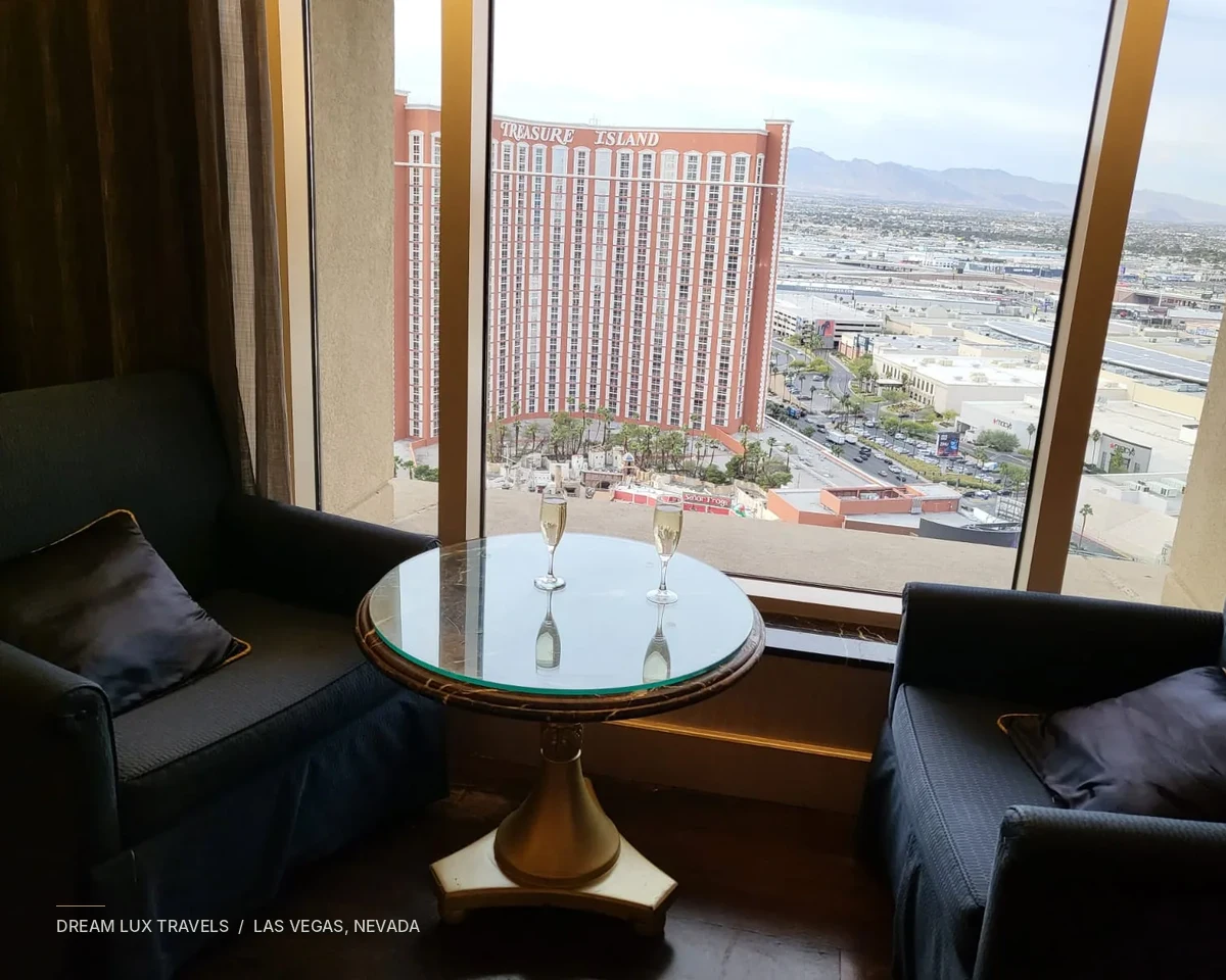 Original Palazzo suite photograph: window seating and two champagne glasses overlooking Las Vegas.